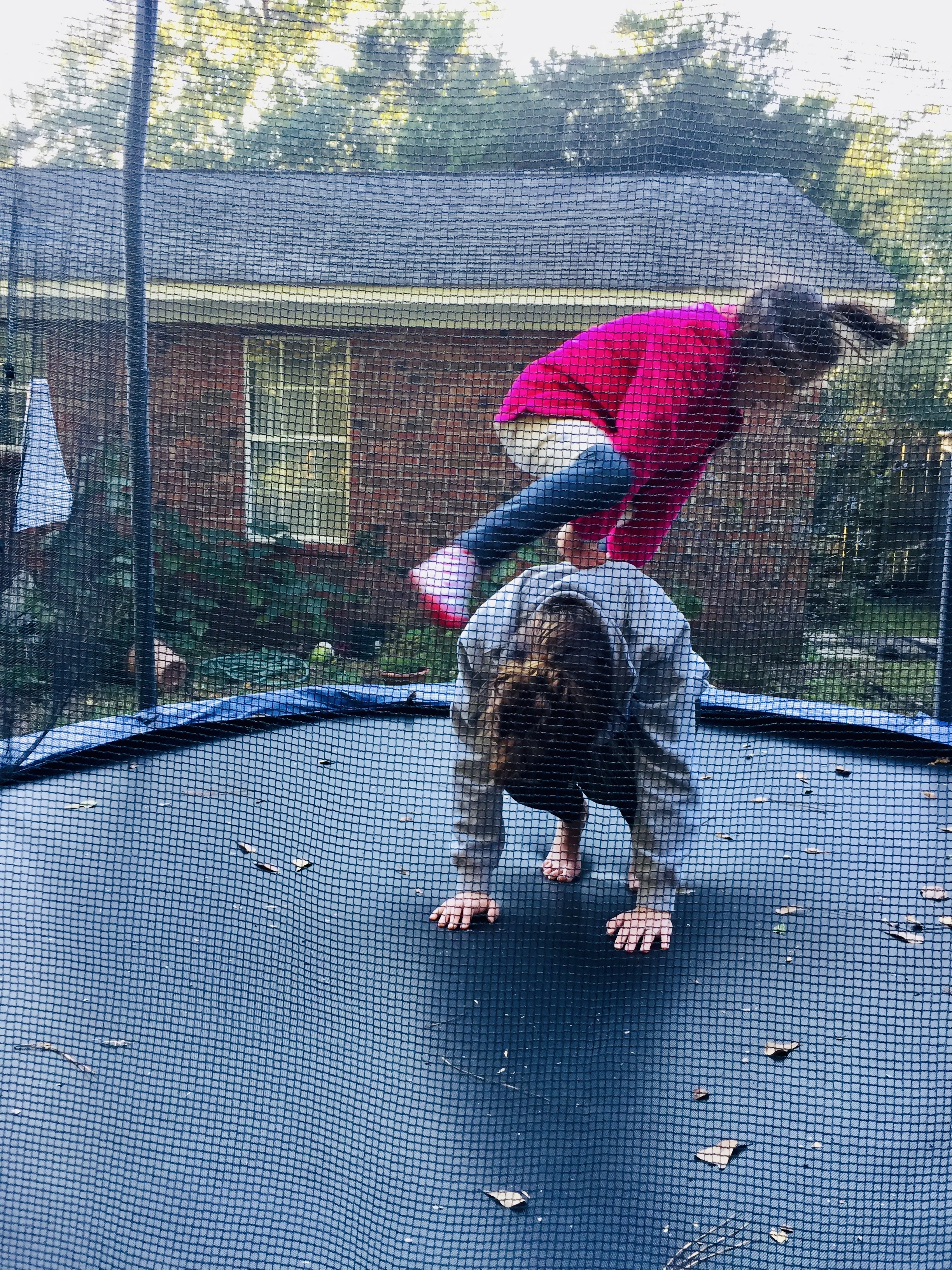 Kids playing outdoors on a trampoline